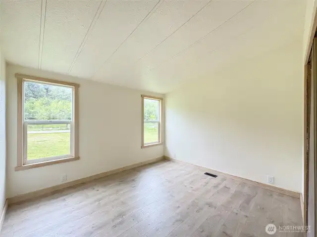 Another view of the first bedroom with two windows for light.