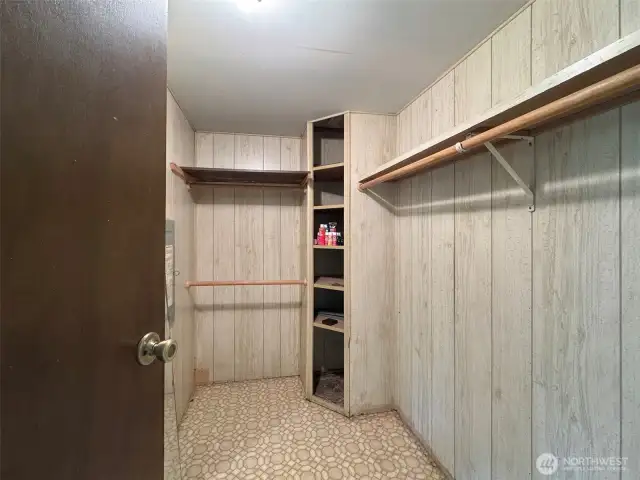 Walk in closet in the primary bedroom.