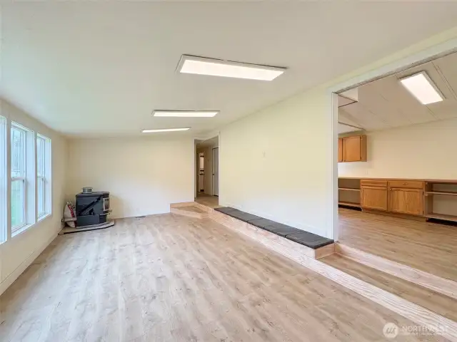 The living room and view of part of the kitchen. Notice the new flooring that is through out the home.