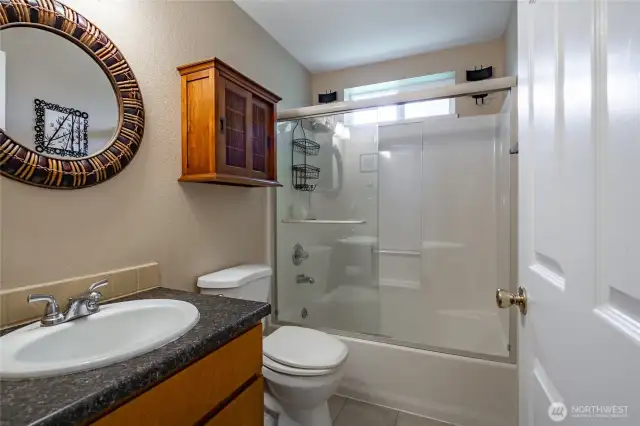Guest full bath. Baths have tile floors.