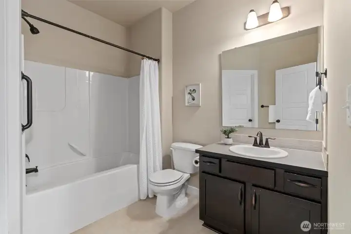 Ensuite bath located off of the ground floor bedroom with it's own walk-in closet.