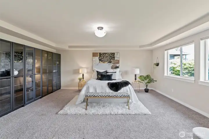 Spacious primary bedroom with stunning water views.