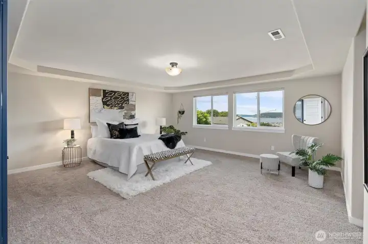 Spacious primary bedroom with stunning water views.