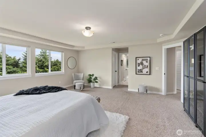 Spacious primary bedroom with stunning water views.
