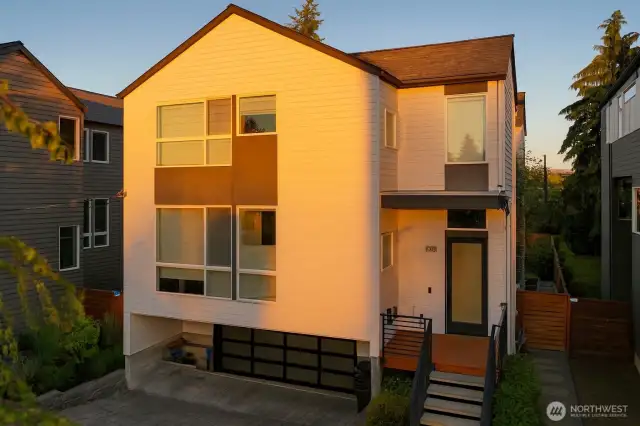 Front of home, driveway with 2-car garage including EV charging station, walk-up entrance to front door