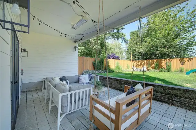 Lower level patio includes built-in heater and built-in two-person swing