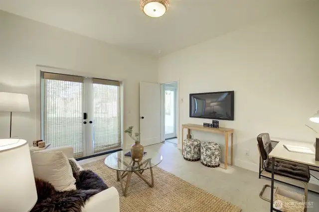 Lower level bedroom with double door entrance to heated patio