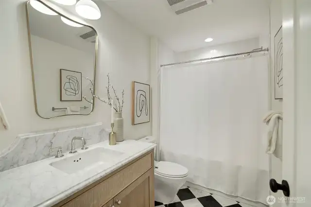 Lower level bathroom featuring AnnSacks Carrara marble tile and countertop, Fuller fixtures, Bedrosian shower tiles