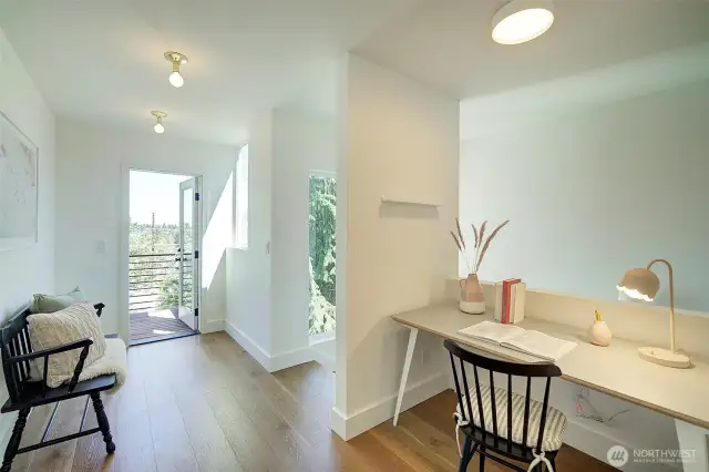 Landing area on upper floor heading towards bedrooms, entrance to upper floor patio on the left
