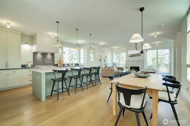 View of kitchen and dining area, custom imported light fixtures, hardwood floors
