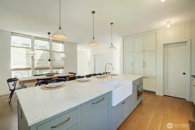View of island shows built-in dishwasher, built-in microwave - door to the right leads to pantry
