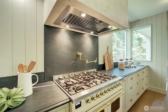 Imported Italian ILVE range, double oven, pot-filler faucet, lime wash hood, soapstone countertops and backsplash