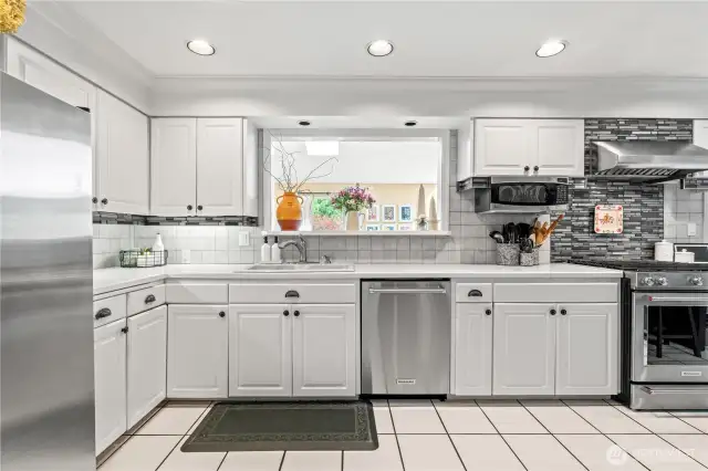 Kitchen peephole overlooks second dining room and brings in so much extra light!