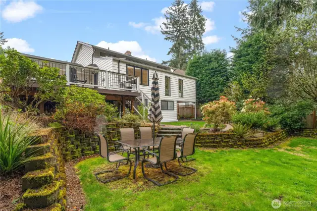 Additional seating or play area on lower terrace in the lush back yard