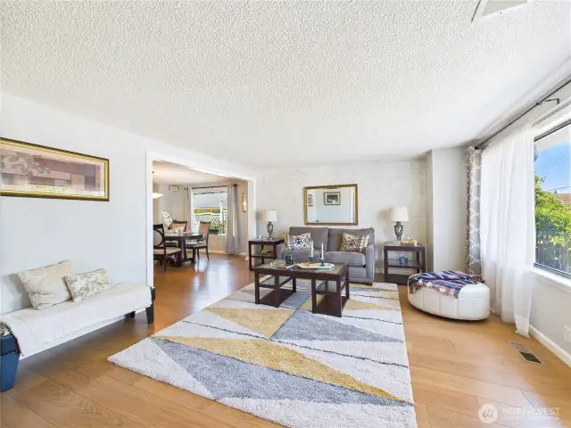 Light laminate flooring and serene colors gives this home an airy feel.