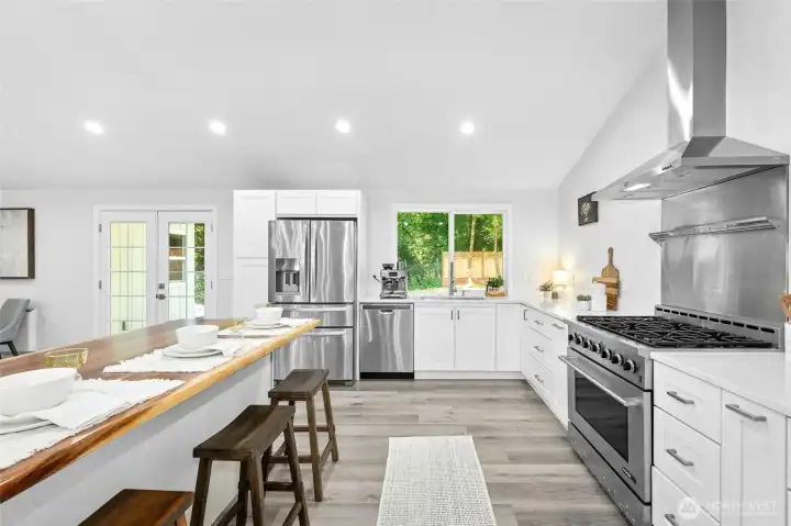Completely renovated in 2023, the home features a gourmet chef’s kitchen with cathedral ceilings, a butcher block island, quartz countertops, stainless steel appliances, and a large walk-in pantry.