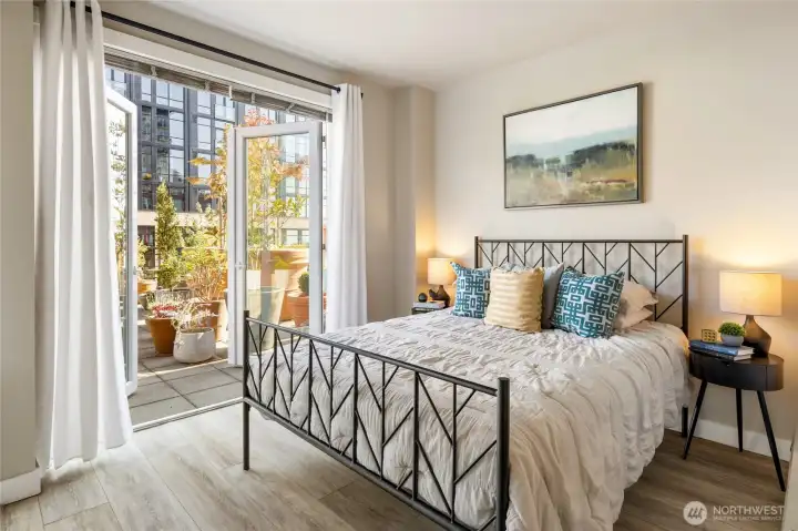 The primary bedroom looks out to the terrace so you can wake to soft morning sun and fall asleep beneath twinkling city lights.