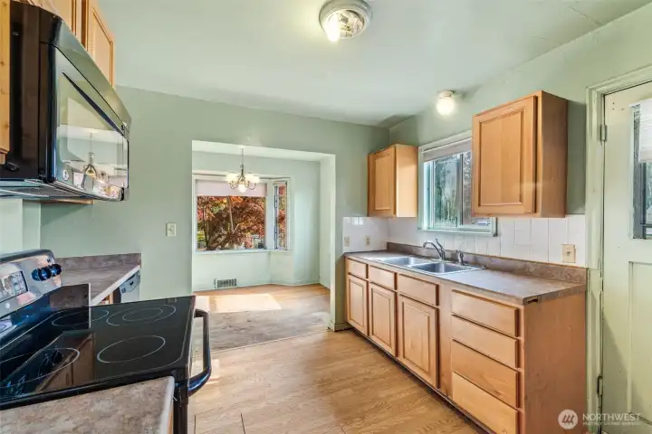 Kitchen opens to dining area—large enough for a full modern update.