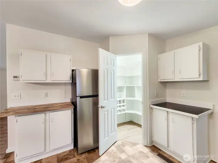 Custom shelving maximizes every inch of this pantry, offering abundant storage and easy access for all your cooking and household supplies.