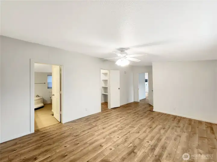 Expansive room with two walk-in closets and space for an office or reading nook.