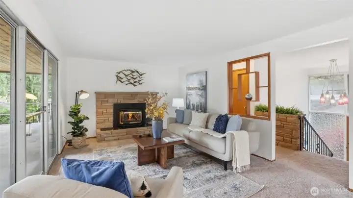 Warm and welcoming living space with a wood-burning insert and large sliding doors that bring the outdoors in.