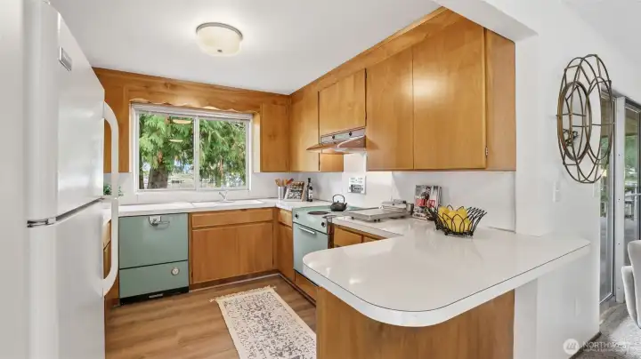 Classic mid-century kitchen with abundant cabinetry and roomy counters that make cooking simple and enjoyable.