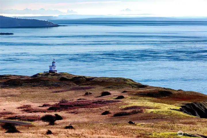 Iconic coastal lighthouse perched above the shoreline, capturing the dramatic scenery and maritime heritage of the Cape San Juan area.