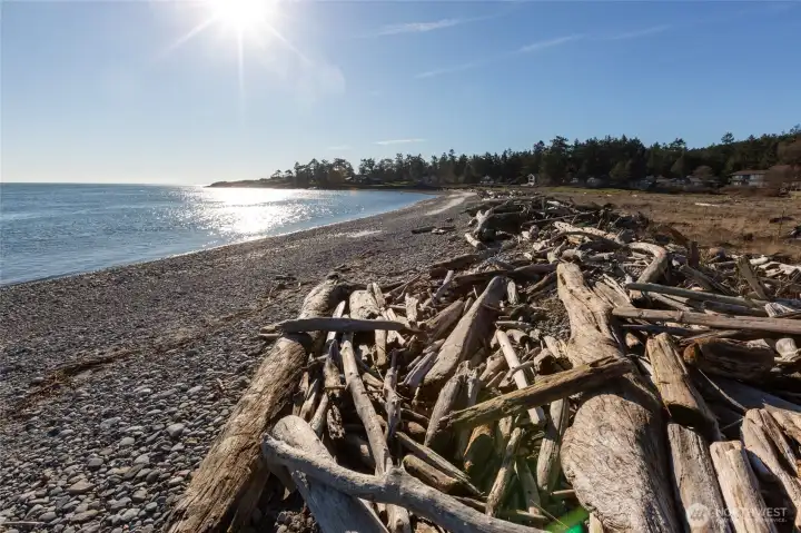 Panoramic shoreline perspective featuring expansive water views and neighboring coastal homes within the Cape San Juan community.