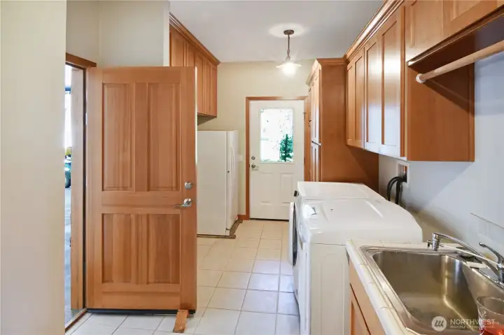 Spacious utility/laundry room with ample storage and direct access for everyday convenience.