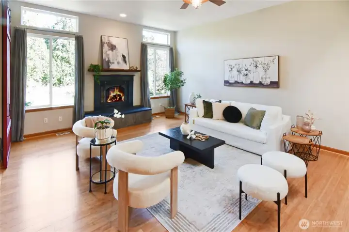 Inviting living room with large windows, cozy fireplace, and open layout ideal for gathering.