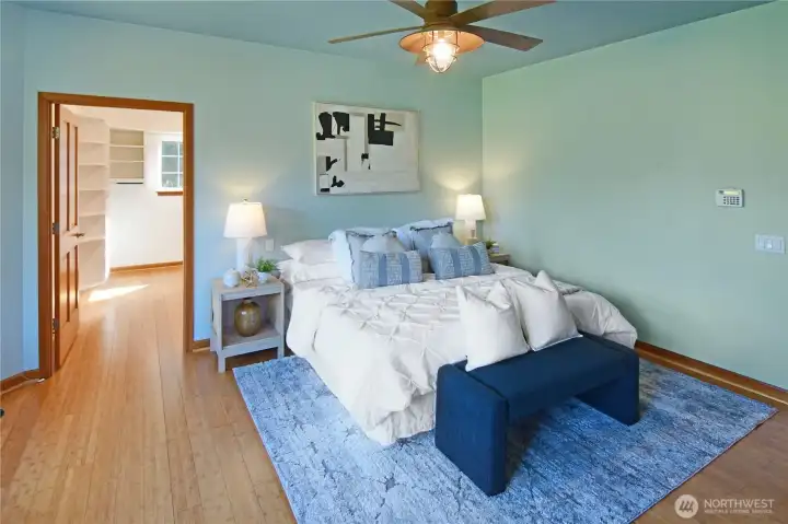 Private primary retreat with sitting area, large windows, and easy single-level comfort. Quality solid fir doors and trim and ceiling fan are great features. The light and bright walk-in-closet is amazing.