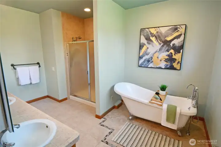 Well-appointed primary bath with clean finishes, easy-access layout, and luxurious heated floors.