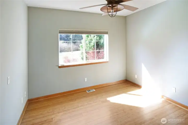 Bright second bedroom with large window, wide entry, and flexible use for guests or office. Generous closet space.