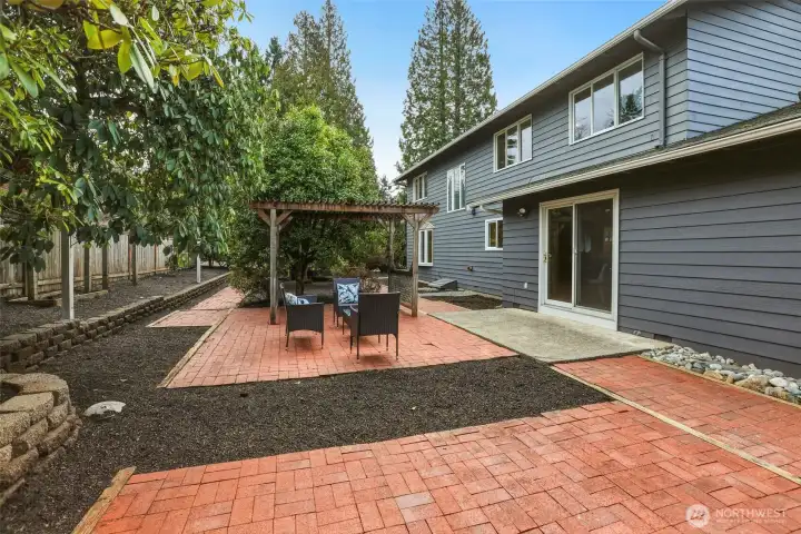 Big, private backyard with red brick pavers, fire pit area, lots of gardening space and room to enjoy.