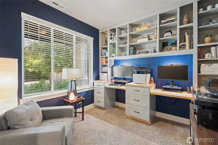 As you enter the home, the office is to the left. The office space w/desks and shelving is custom. It's a great space to work from home.