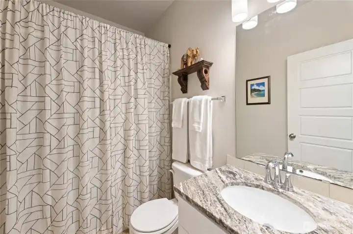 Just beyond the stairs and coat closet lies a .75 bath on the main level. Strategically situated away from the kitchen.