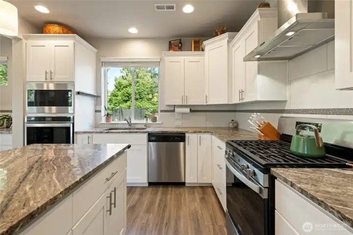 The fridge is just behind the view and to the immediate right.