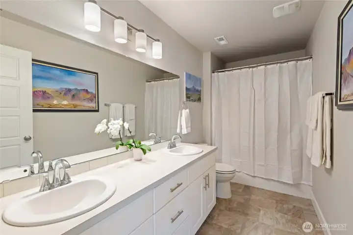 As you enter the 2nd level, this is the common, full-bath. Situated to the left of the laundry room and in close proximity to the 3 bedrooms on the second level.