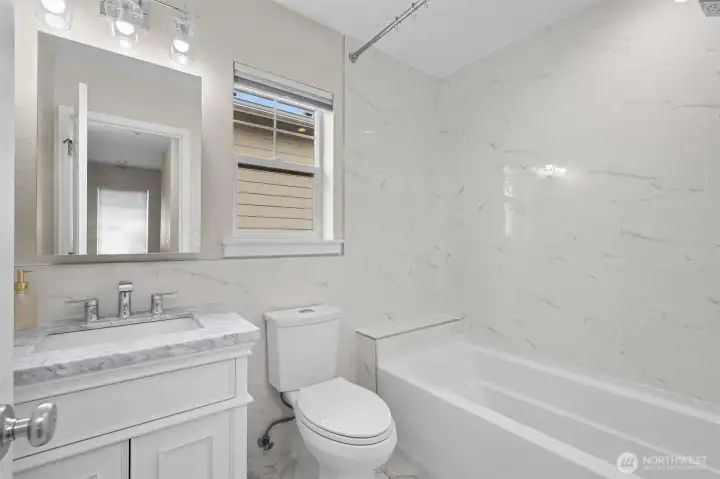 The remodeled full bath in the hallway supports the two bedrooms.