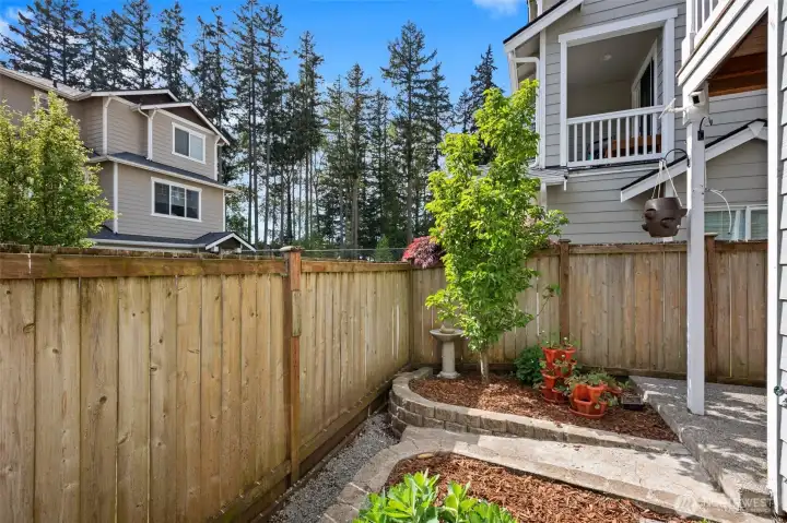 The yard is sun drenched and offers a peaceful oasis.