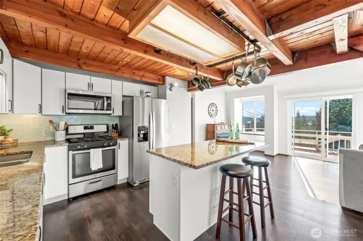 Natural light pours through oversized windows, illuminating the open kitchen featuring stainless steel appliances, quartz countertops & warm gathering spaces. Natural light pours through oversized windows, illuminating the open kitchen featuring stainless steel appliances, quartz countertops & warm gathering spaces.