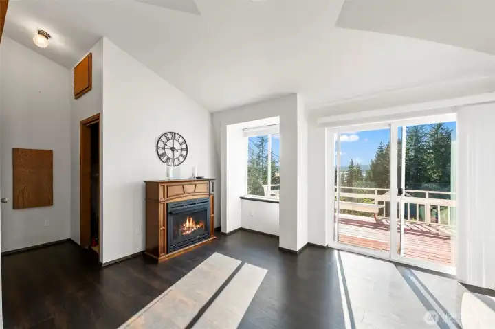 Cozy open-concept living room featuring a warm fireplace, durable flooring & inviting spaces designed for relaxed Pacific Northwest lake living.” Cozy open-concept living room featuring a warm fireplace, durable flooring & inviting spaces designed for relaxed Pacific Northwest lake living.”