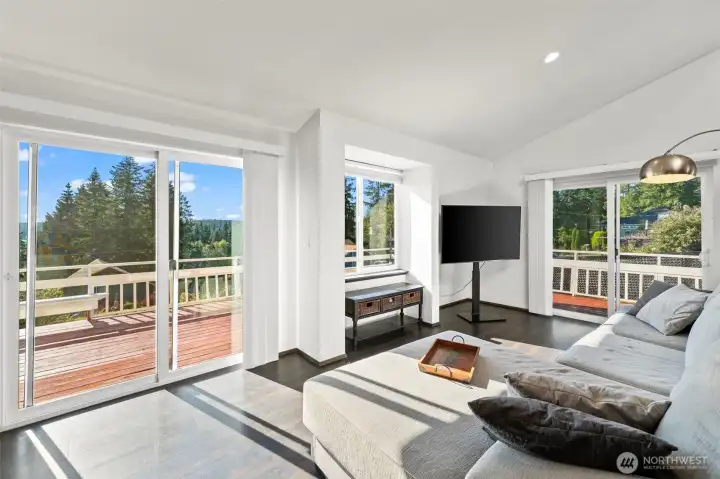 Vaulted ceilings, expansive windows & peek-a-boo Mason Lake views fill the living room with natural light and timeless Pacific Northwest charm. Vaulted ceilings, expansive windows & peek-a-boo Mason Lake views fill the living room with natural light and timeless Pacific Northwest charm.