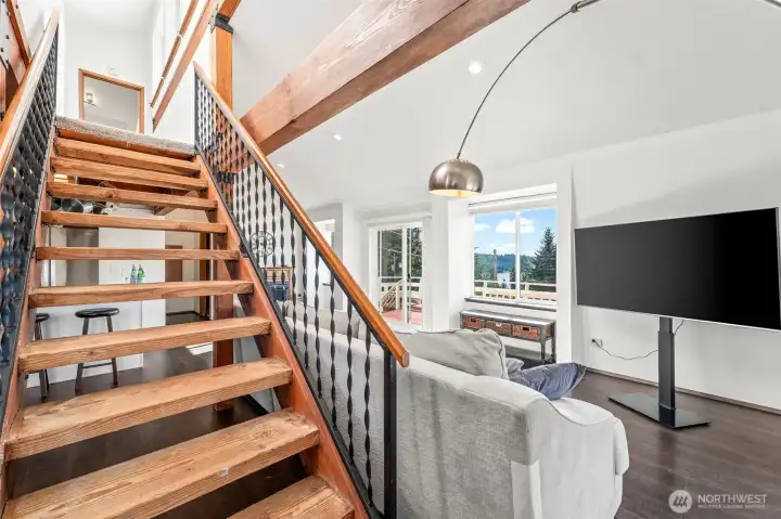 Open stairway leads to a private loft retreat featuring an additional bedroom and full bath—ideal for guests, flexible living or a peaceful getaway space. Open stairway leads to a private loft retreat featuring an additional bedroom and full bath—ideal for guests, flexible living or a peaceful getaway space.