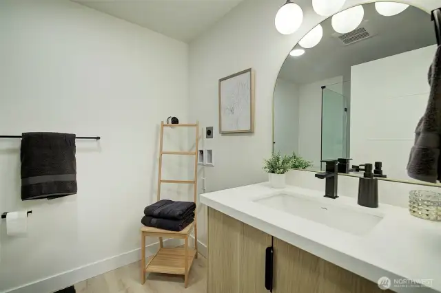 The downstairs 3/4 bathroom was built-out to house a full size stackable washer and dryer.