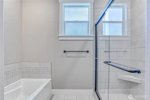 Shower has custom tile to ceiling