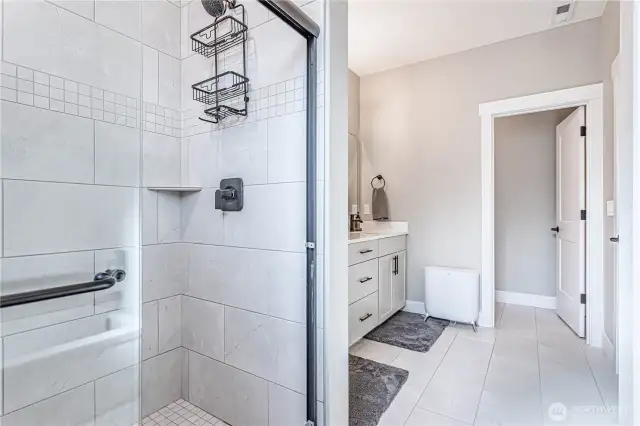 Shower has custom tile to ceiling