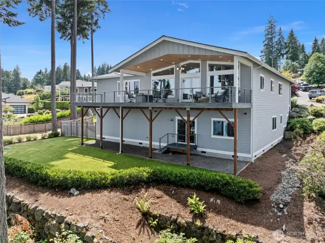 Looking at the back of them home seeing the large deck and yard