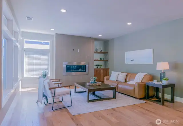 Great room features modern gas fireplace and built in cabinetry