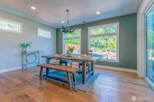 Spacious dining area with views to the backyard, and drenched in light from the oversized windows